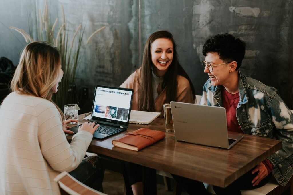 | Chill & Thrive three women chatting and laughing while working