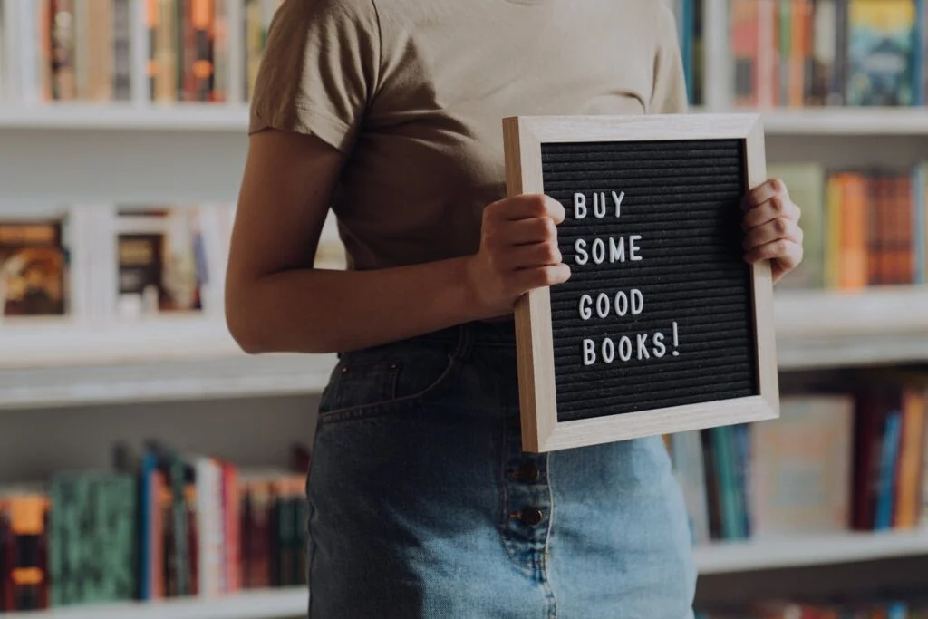 Photo by cottonbro studio | Chill & Thrive | Chill & Thrive Man in Brown Crew Neck T-shirt and Blue Denim Jeans Holding Black and White Book