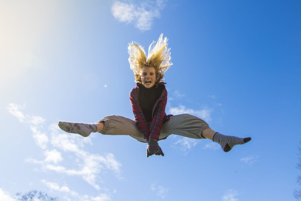 | Chill & Thrive Woman Jumping Under Blue Sky