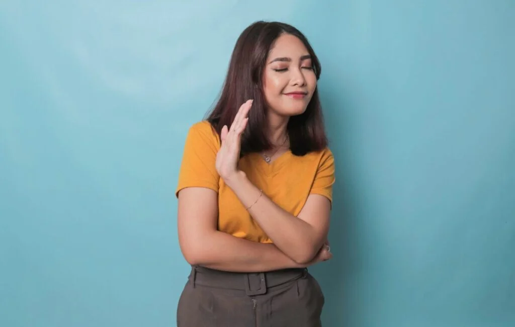 Stop Concerned Asian woman showing refusal sign saying no raise awareness standing over blue background | Chill & Thrive learn to set boundaries