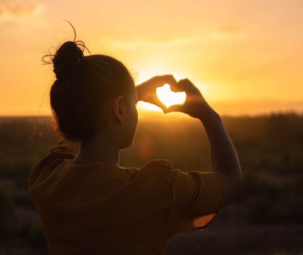 | Chill & Thrive Woman Sitting While Showing Heart Sign Hands